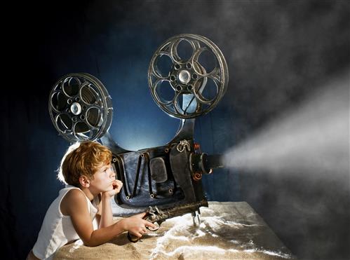 girl watches projector reel